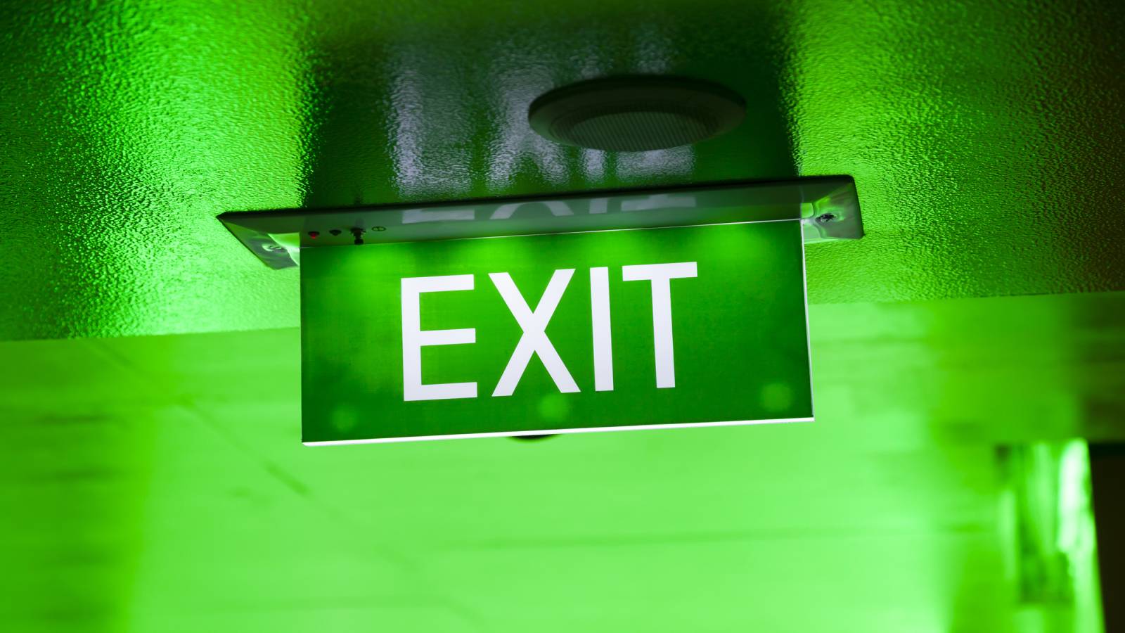 A green illuminated exit sign