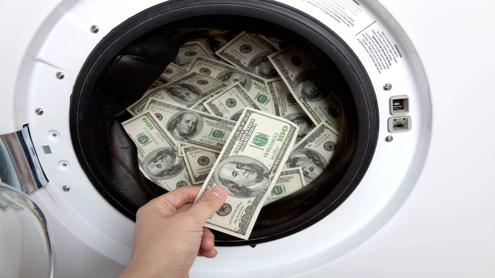 A man pulls out money from a washing machine