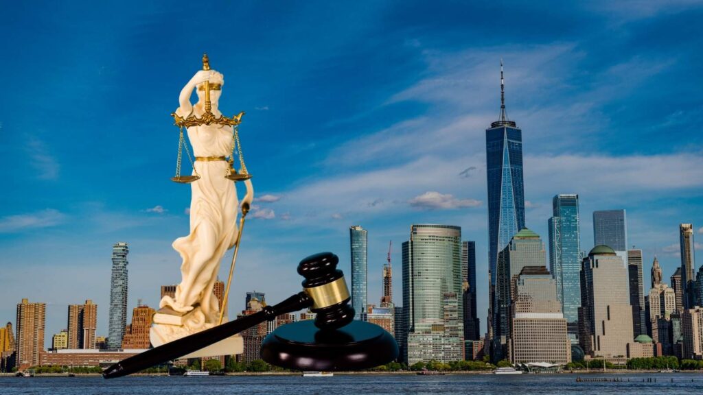 The scales of justice and a gavel, superimposed across a NY skyline to indicate a discussion on NY laws.